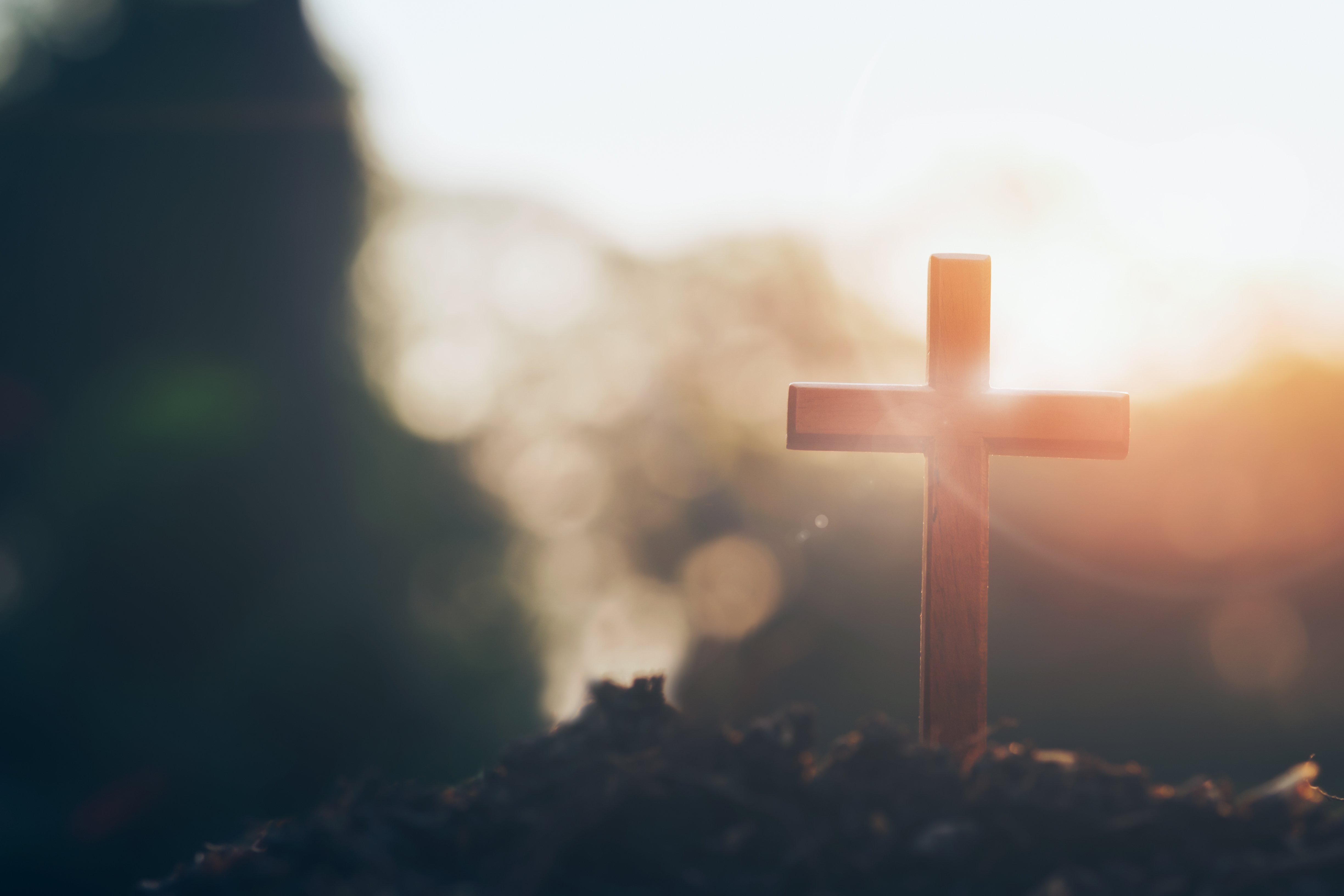 cross on blurry sunset background. Christian, Christianity, Religion copyspace background.